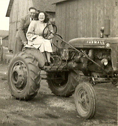 Lawrence - Catherine Lucas on Farmall A tractor